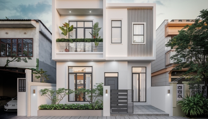 Gam trắng thanh lịch kết hợp cửa kính khung xám than tạo nên sự đồng điệu hiện đại và tinh tế cho mặt tiền nhà ống 2 tầng.