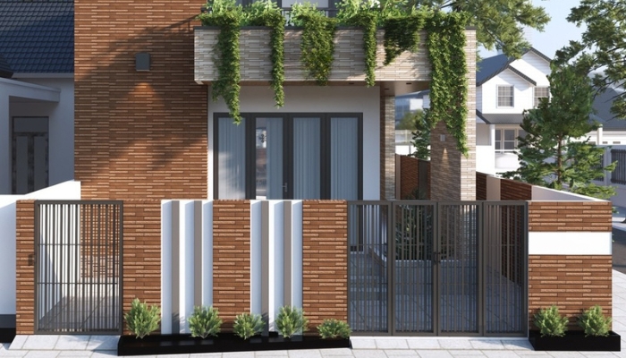 Sử dụng gạch ốp cổng màu nâu đỏ làm điểm nhấn, kết hợp với các mảng tường trắng tạo sự hài hòa
